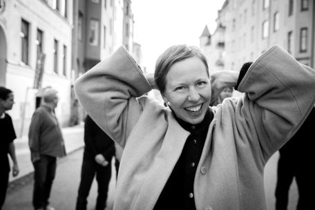 image of Anna on a street with her hands behind her head